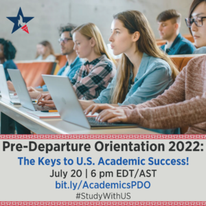 A girl with a laptop in a classroom looks towards the front of the room