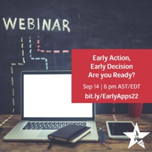 open laptop, the word "webinar" on a chalkboard